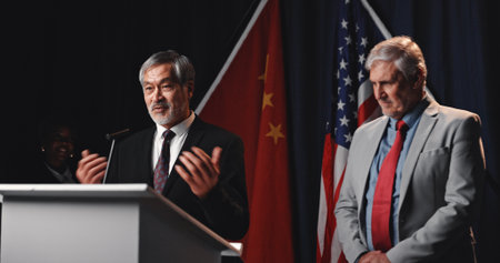 Election, politicians and men on podium for speech with mic for democratic selection at debate. Campaign, discussion and male candidates with press conference for votes on stage for public relations.の写真素材