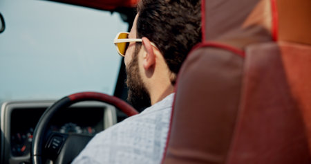 Driving, travel and back of man in car for holiday destinations, explore and weekend break. Tourist getaway, vacation and road trip journey with person in vehicle for motor and transportationの写真素材