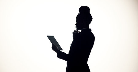 Thinking, tablet and business person in studio for brainstorming, online proposal and reflection. Space, mockup and woman on tech with ideas, solution or planning for project on white backgroundの写真素材