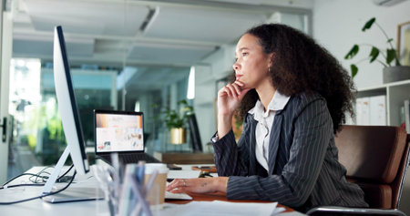 Media agency, thinking and woman in office, computer and online reading with email for submission. Person, copywriting and journalist with pc, article or magazine website with publication or creativeの写真素材