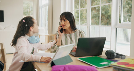 Remote work, phone call and mom with child in home for help with homework, online learning and studying. Family, busy and woman with girl at table for working, education and virtual career on techの写真素材