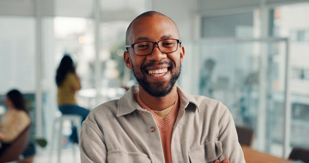 Office, creative and portrait of happy businessman with confidence, pride and laugh for editor career. Media agency, about us and person with smile for copywriting, news reporter job and publishingの写真素材