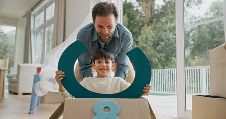 Father, child or playing in box in new home for property investment, game or mortgage security....