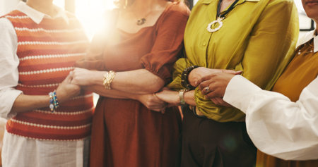Holding hands, old women and friends with unity, solidarity and bonding together with comfort. Pensioners, closeup and people with gesture, support and trust with faith, worship and communityの写真素材