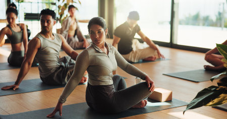 Yoga class, floor or group stretching in studio, holistic exercise or posture practice in morning. Fitness training, pilates or calm people with mat for warm up, healing session or zen in health clubの写真素材