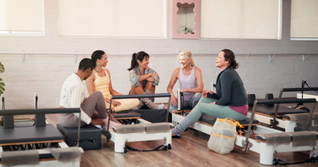 Pilates, talking and trainer with women in gym for fitness advice, workout tips and exercise. Health...