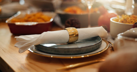 Christmas, feast and napkin with place setting on dining room table for social gathering. Banquet, celebration event and ring on serviette in home for decoration, meal or party in holiday seasonの写真素材