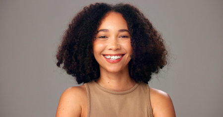 Studio, haircare and woman with smile, portrait or cosmetics for texture, shine and white background. Happy, African person and confident for hair maintenance, growth and self care for hairstyleの写真素材