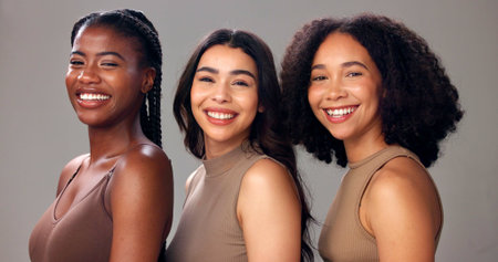 Happy women, portrait or natural beauty with diversity, skin tone or cosmetics on studio background. Female people, interracial or multiracial with smile for skincare, health or wellness in salonの写真素材