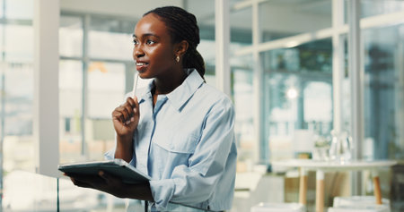 Business, tablet and thinking with black woman in office for planning, problem solving or research. App, schedule and vision with African employee in workplace for company agenda or managementの写真素材