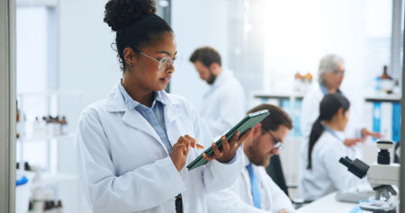 Scientist, woman and tablet in laboratory for development, medical research or innovation. Science,...