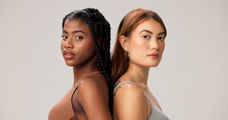 Beauty, portrait and women in studio together for cosmetics, dermatology or inclusive skincare. Aesthetic, confidence and support with serious friends isolated on white background for cosmetologyの写真素材