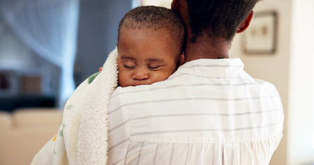 Home, hug and mother with baby, care and bonding together with love, support and comfort. Family, mama and infant with embrace, sleeping and childhood with safety, nap and security at house.の写真素材