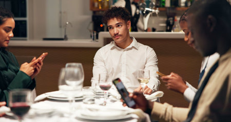 Man, bored and group at restaurant with phone addiction, social isolation and annoyed at dinner....