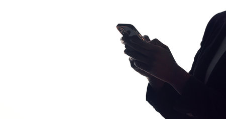 Hands, business and person with cellphone, internet and communication on white studio background. Mockup space, employee and consultant with smartphone, silhouette and social media with notificationの写真素材