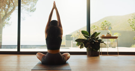 Woman, back view and zen with namaste for meditation, yoga or spiritual wellness in serene studio. Calm, female person or yogi with inner peace or balance for mudra, mindfulness or chakra in dojoの写真素材