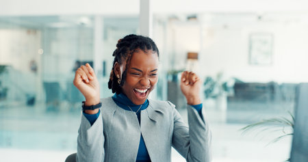 Excited, woman and celebration with computer in office for article success, journalism award or email. Journalist, black person and victory fist for trending topic, career achievement and good newsの写真素材