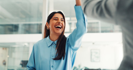 Woman, high five and smile with celebration at startup, goals or motivation for team at media company. Person, happy and support with thanks, agreement or success with achievement at creative agencyの写真素材