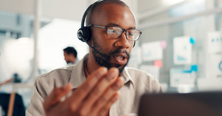 Telemarketing, laptop and man with headset, call center and discussion with contact, offer or online. Customer service, glasses and person with mic for communication, lead generation and reflectionの写真素材