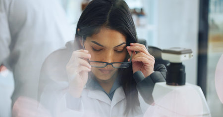 Scientist, woman and glasses in laboratory for vision, medical research or innovation development....