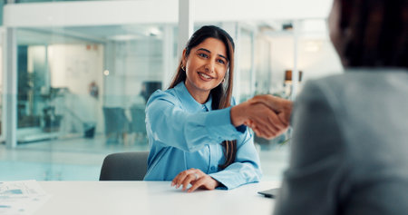 Woman, handshake and happy with hiring, welcome and recruitment process with deal at company. Person, human resources and shaking hands with smile, agreement and onboarding with success at agencyの写真素材