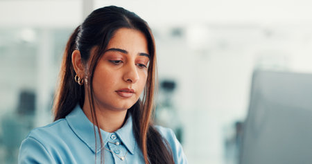 Reading, office and business person on laptop for finance report, online research and proposal. Professional, corporate and worker typing on computer for financial review, website and budget planningの写真素材