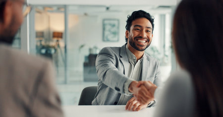Business, man and handshake with people in meeting for negotiation, deal and legal settlement. Attorney, clients and shaking hands at law firm for crisis resolution, court case and mediation processの写真素材