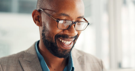Black man, smile and glasses at office with review, good news and excited with project at media company. African person, writer and feedback for proposal, editing article or happy at creative agencyの写真素材