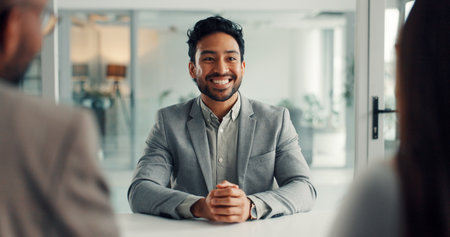 Office, interviewer and man with people, hiring and happy for recruitment process, talk and meeting. Business, HR manager and discussion with candidates for job vacancy, onboarding and opportunityの写真素材