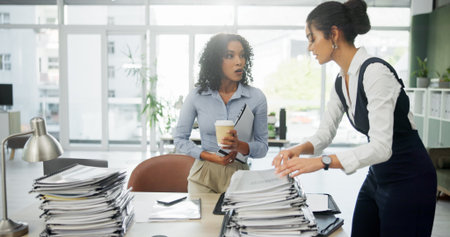 Women, stress and overwhelmed with stack, documents and surprise with overtime at finance company. People, shock and crisis with admin, paperwork and workload increase for team at insurance agencyの写真素材