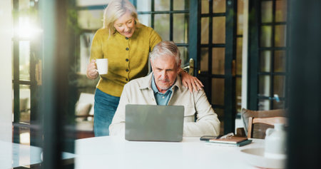Senior couple, talk and research with laptop, love and discussion for retirement, online and support. Financial planning, elderly man and old woman with coffee in home, flare or investment on websiteの写真素材
