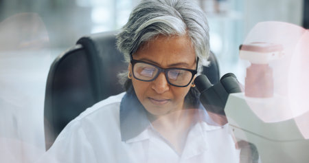 Science, medical research and woman with microscope, sample analysis and forensics test. Mature person, solution and scientist in laboratory, equipment and vaccine development with problem solvingの写真素材