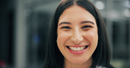 Dental, portrait and woman in clinic with smile, mouth and tooth wellness in orthodontics. Bokeh, happiness and female person in hospital with hygiene, whitening and dentistry in oral health.の写真素材