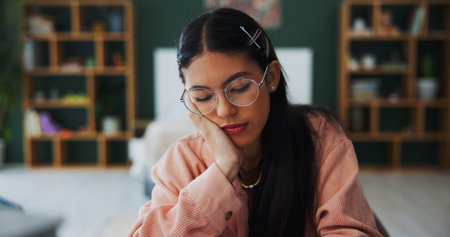 Tired, woman and student sleep at house from studying, learning fatigue and exhausted. Bored, female person and nap from education pressure, university workload and overworked learner from assignmentの写真素材