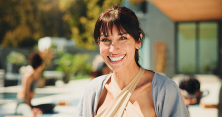 Exercise, portrait and smile of happy yoga instructor outdoor for class or lesson with students at...