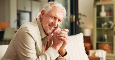 Calm, smile and portrait of old man on sofa of home for retirement, peace and confidence. Happiness, relax and weekend break with senior person in living room of apartment for positive attitudeの写真素材