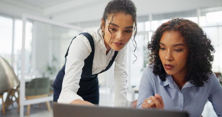 Woman, team and computer at office with review, planning and discussion for investment opportunity. People, broker and partner with pc, point or feedback for stock market research at finance agencyの写真素材