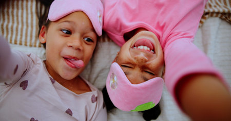 Selfie, above and funny with kids, sleepover or portrait with memory, girls and bonding together. Home, friends or children with profile picture, happiness or photography with love, humor or laughingの写真素材