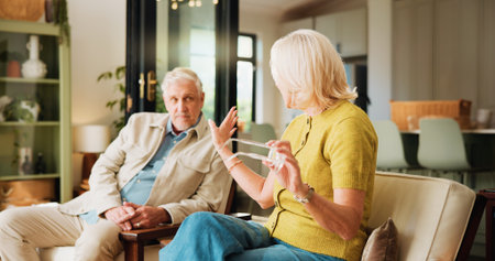 Sofa, senior couple with argument in home. Retirement, old people and disagreement in house for relationship, marriage or conflict.の写真素材