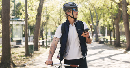 Shipping, bike and phone with man in park for package distribution, delivery route app and courier. Online order, cycling and ecommerce parcel with person and mobile outdoor for export and cargoの写真素材