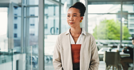 Lobby, thinking and business woman serious in office for future, planning or vision of career development. Idea, opportunity and optimism with happy creative employee in workplace for inspirationの写真素材