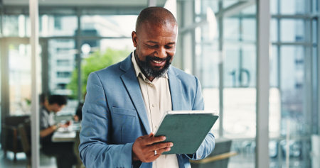 Tablet, smile and business man in office for financial report, email or communication online. Tech, mature consultant and person in workplace with investment feedback, wealth management or researchの写真素材