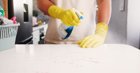 Cleaning, hands and spray in kitchen with disinfectant, housework or sanitation of countertop....