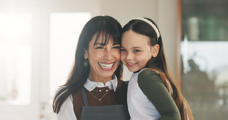 Portrait, mother and happy with child at house for love, trust and bonding together with support. Smile, woman and laugh with kid for affection, playful family and relationship connection in loungeの写真素材