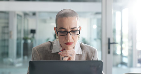 Thinking, corporate and woman with laptop in office for research, planning and finance report. Accountant, vision and pc for financial audit, review budget and problem solving for investment proposalの写真素材