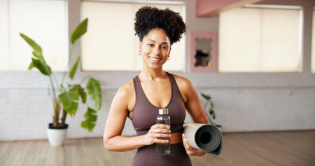 Portrait, fitness and woman in studio, water bottle and smile with wellness, yoga mat and exercise....