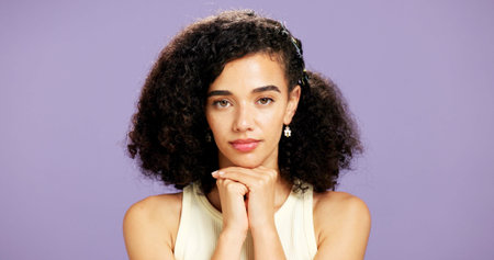 Portrait, serious and woman with beauty in studio for hydration, healthy skin and makeover change. Proud, gen z and person with makeup for aesthetic, cosmetology and self care on purple backgroundの写真素材
