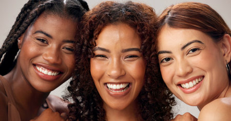 Portrait, women or skincare in studio with smile for diversity, connection or bonding together. Confident, happy people or beauty aesthetic with inclusion, solidarity or unity for group empowerment.の写真素材