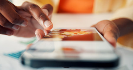 Cellphone screen, hands and person in office with scrolling for order food for delivery on mobile app. Phone, tech and closeup of employee on website for takeaway menu on lunch break in workplace.の写真素材