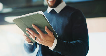 Man, realtor and hands in office with tablet, property management and service review. Schedule, estate agent and digital tech in agency for commission update, app scroll and research for readingの写真素材